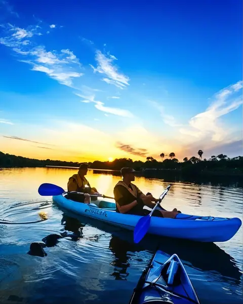 Two paddlers drifting home at sunset